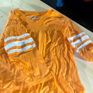 V-neck orange shirt.